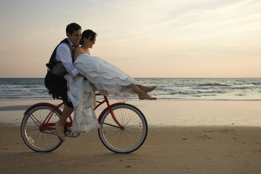 Bride and groom riding a bike